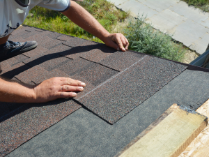image of damaged shingles on a Tiburon home's roof being repaired