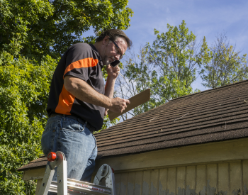 A Northern Pacific Roofing team member conducting an inspection